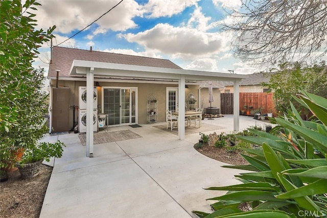 2025 N Buena Vista St, Burbank, CA 91504 - back of house featuring stacked washing machine and dryer, a patio, stucco siding, and roof with shingles