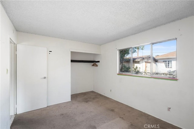 3825 Lofton Pl, Riverside, CA 92501 - unfurnished bedroom featuring a textured ceiling, carpet floors, and a closet