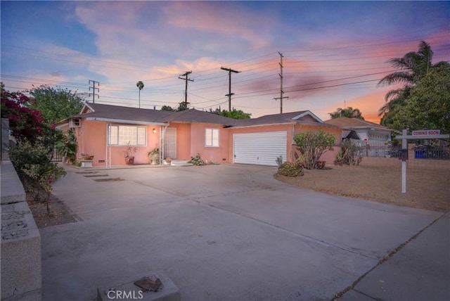 3825 Lofton Pl, Riverside, CA 92501 - ranch-style home featuring driveway, stucco siding, and an attached garage