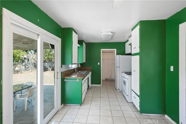 3825 Lofton Pl, Riverside, CA 92501 - kitchen featuring white range with gas cooktop, a sink, light tile patterned floors, and baseboards