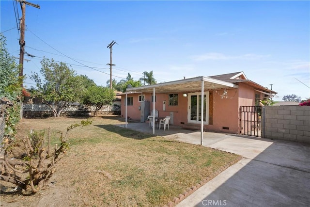 3825 Lofton Pl, Riverside, CA 92501 - rear view of property featuring a patio, stucco siding, and a gate