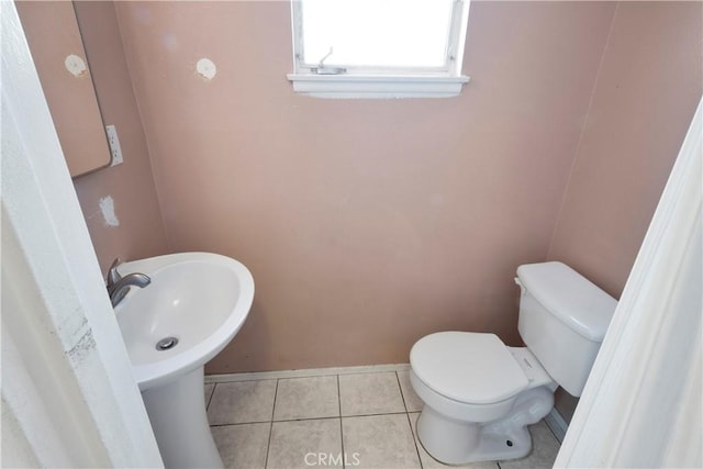 3825 Lofton Pl, Riverside, CA 92501 - half bath featuring toilet, tile patterned flooring, and baseboards