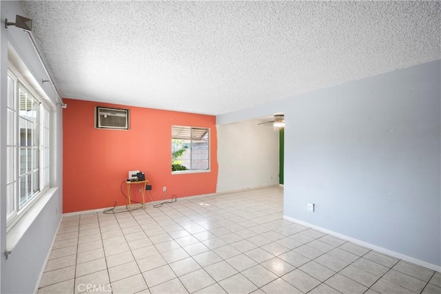 3825 Lofton Pl, Riverside, CA 92501 - unfurnished room with an AC wall unit, a textured ceiling, healthy amount of natural light, ceiling fan, and light tile patterned floors