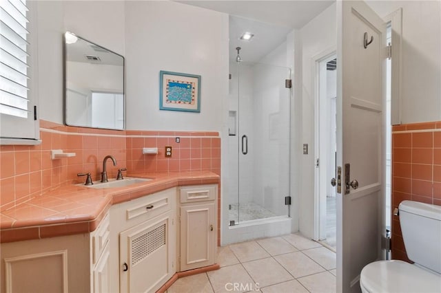 4455 Atoll Ave, Sherman Oaks, CA 91423 - full bath with vanity, tile patterned floors, a shower stall, toilet, and tile walls