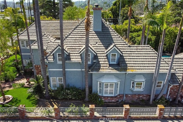 4455 Atoll Ave, Sherman Oaks, CA 91423 - view of home's exterior featuring stucco siding, a chimney, and a tiled roof