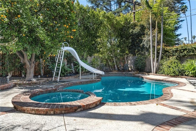4455 Atoll Ave, Sherman Oaks, CA 91423 - view of pool featuring a water slide, a fenced backyard, a pool with connected hot tub, and a patio