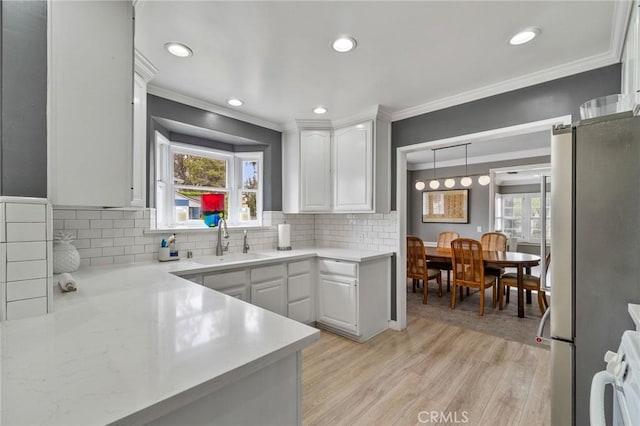 4455 Atoll Ave, Sherman Oaks, CA 91423 - kitchen featuring a sink, freestanding refrigerator, white cabinetry, light countertops, and crown molding