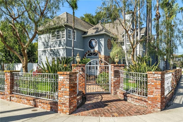 4455 Atoll Ave, Sherman Oaks, CA 91423 - tudor-style house featuring stucco siding and a gate