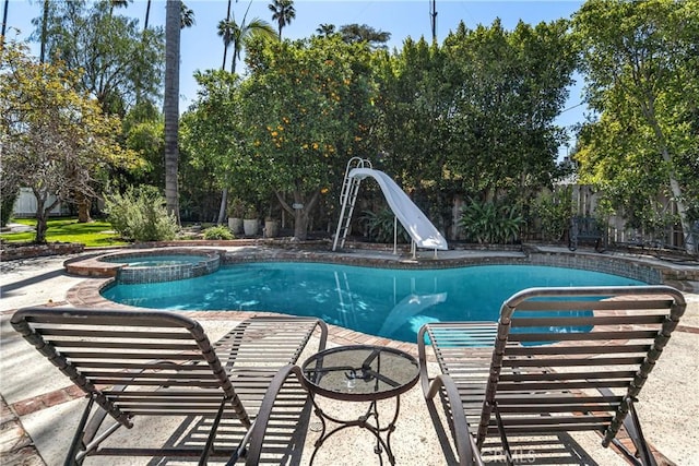 4455 Atoll Ave, Sherman Oaks, CA 91423 - view of swimming pool with a water slide, a fenced backyard, and a pool with connected hot tub