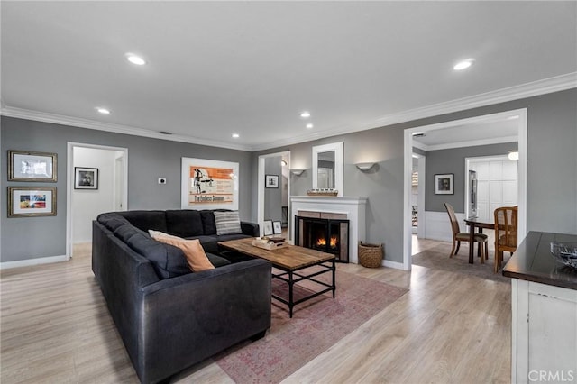 4455 Atoll Ave, Sherman Oaks, CA 91423 - living area with light wood finished floors, recessed lighting, a lit fireplace, baseboards, and crown molding