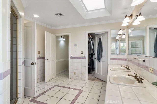 4455 Atoll Ave, Sherman Oaks, CA 91423 - full bathroom with a chandelier, tile patterned flooring, double vanity, crown molding, and tile walls