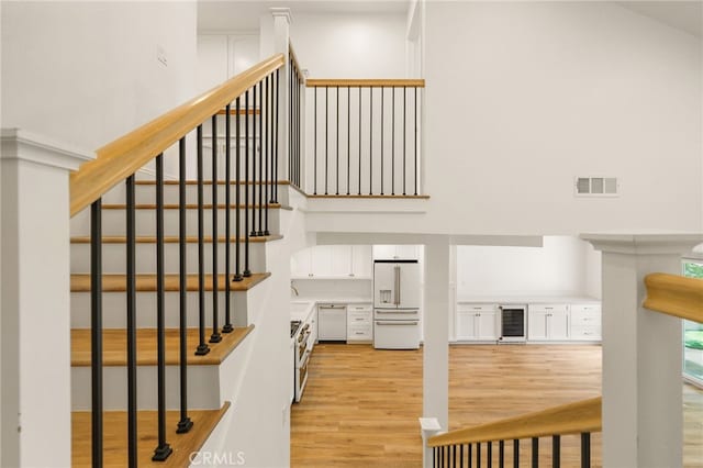 19464 Turtle Ridge Ln, Porter Ranch, CA 91326 - stairway with wine cooler and wood finished floors