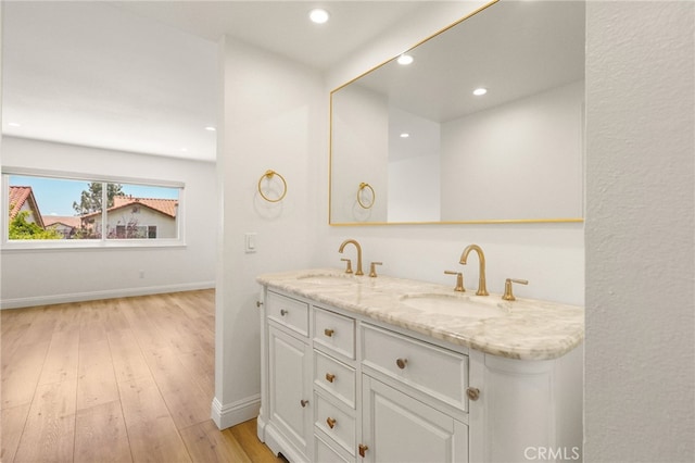 19464 Turtle Ridge Ln, Porter Ranch, CA 91326 - bathroom featuring double vanity, wood finished floors, baseboards, and recessed lighting