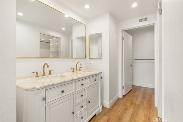 19464 Turtle Ridge Ln, Porter Ranch, CA 91326 - bathroom with double vanity, wood finished floors, recessed lighting, and baseboards