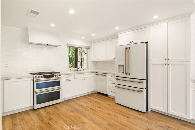 19464 Turtle Ridge Ln, Porter Ranch, CA 91326 - kitchen with white appliances, exhaust hood, light countertops, a sink, and white cabinetry