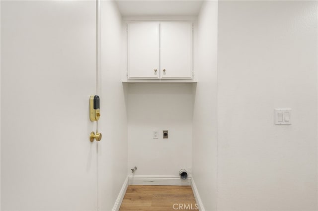 19464 Turtle Ridge Ln, Porter Ranch, CA 91326 - laundry room with cabinet space, light wood-style flooring, hookup for an electric dryer, baseboards, and hookup for a gas dryer