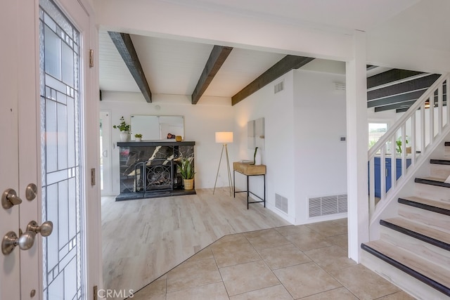 24162 Twig St, Lake Forest, CA 92630 - foyer with beam ceiling, stairs, healthy amount of natural light, wood finished floors, and a stone fireplace