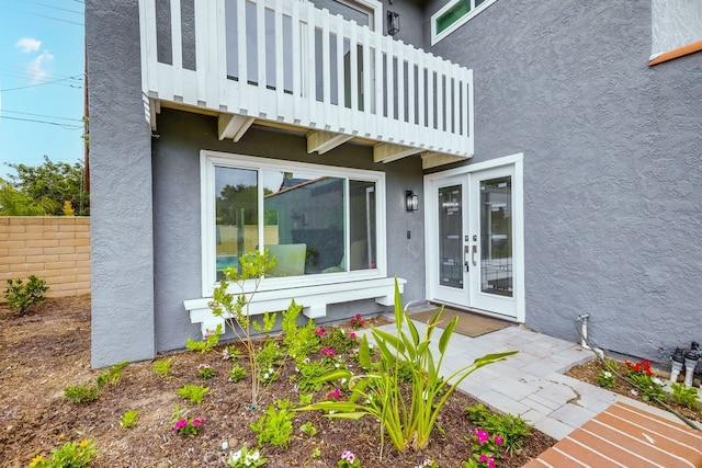 24162 Twig St, Lake Forest, CA 92630 - view of exterior entry featuring stucco siding, a balcony, and french doors