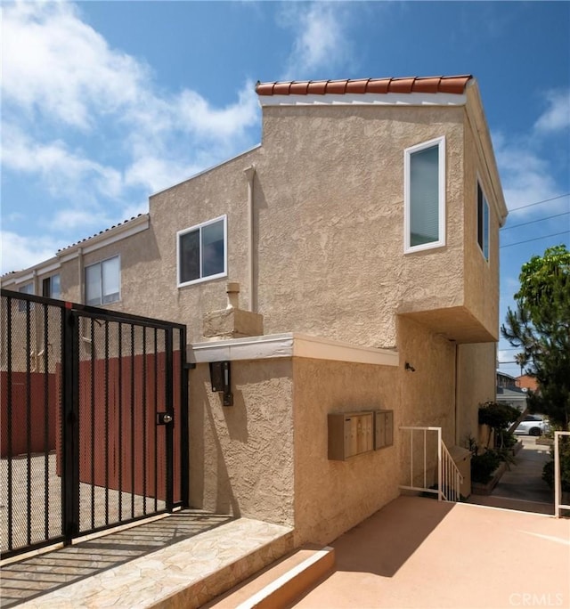 2310 Vanderbilt Ln Unit 4, Redondo Beach, CA 90278 - rear view of house featuring a gate and stucco siding