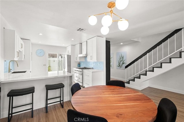 2310 Vanderbilt Ln Unit 4, Redondo Beach, CA 90278 - dining area featuring stairs, a chandelier, wood finished floors, and recessed lighting