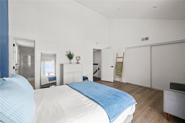 2310 Vanderbilt Ln Unit 4, Redondo Beach, CA 90278 - bedroom with high vaulted ceiling, wood finished floors, a closet, and ensuite bath