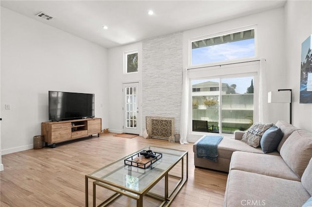 2310 Vanderbilt Ln Unit 4, Redondo Beach, CA 90278 - living area with a towering ceiling, light wood-type flooring, a fireplace, and recessed lighting
