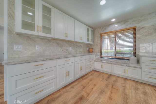 1043 Meadowview Ct, Corona, CA 92878 - kitchen with white cabinetry, glass insert cabinets, light stone countertops, tasteful backsplash, and recessed lighting