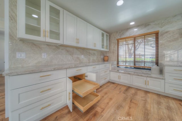 1043 Meadowview Ct, Corona, CA 92878 - kitchen featuring glass insert cabinets, white cabinets, light stone counters, tasteful backsplash, and recessed lighting