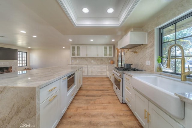 1043 Meadowview Ct, Corona, CA 92878 - kitchen with high end white range oven, ornamental molding, recessed lighting, white cabinetry, and glass insert cabinets