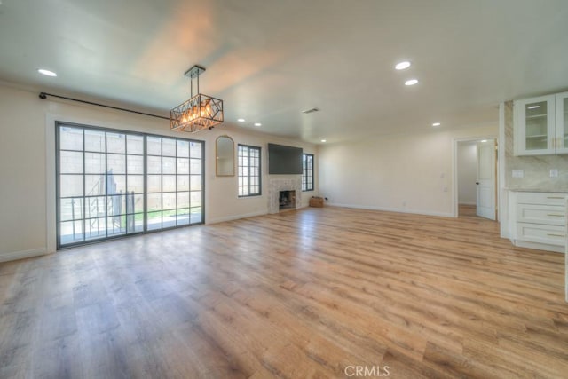 1043 Meadowview Ct, Corona, CA 92878 - unfurnished living room featuring light wood finished floors, recessed lighting, and a fireplace