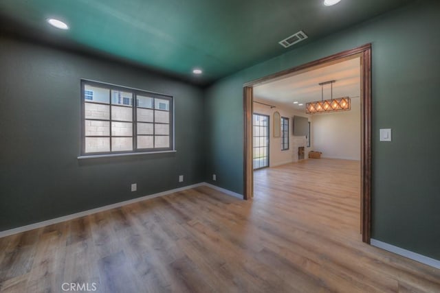 1043 Meadowview Ct, Corona, CA 92878 - spare room with wood finished floors, recessed lighting, and a chandelier