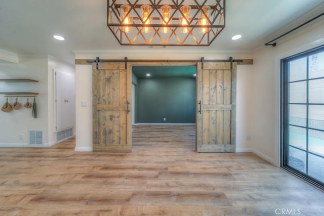1043 Meadowview Ct, Corona, CA 92878 - empty room featuring a barn door, crown molding, recessed lighting, and wood finished floors