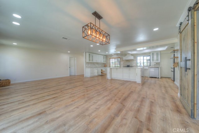 1043 Meadowview Ct, Corona, CA 92878 - unfurnished living room featuring a barn door, light wood-type flooring, and recessed lighting