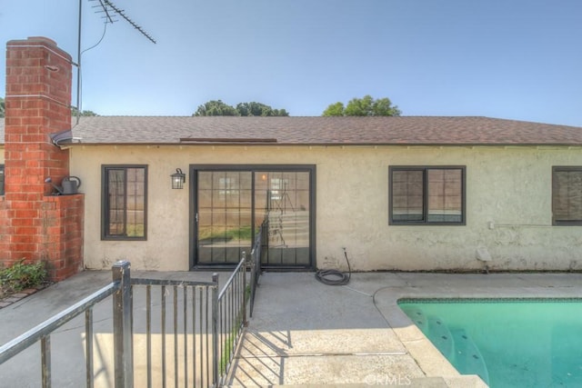 1043 Meadowview Ct, Corona, CA 92878 - back of property with roof with shingles, stucco siding, an outdoor pool, and a chimney