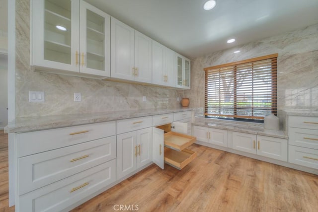 1043 Meadowview Ct, Corona, CA 92878 - kitchen featuring glass insert cabinets, white cabinetry, light stone countertops, backsplash, and recessed lighting