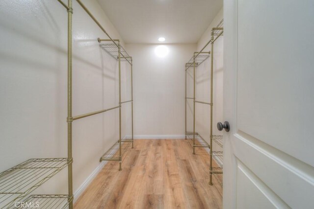 1043 Meadowview Ct, Corona, CA 92878 - spacious closet with wood finished floors