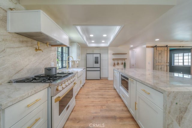 1043 Meadowview Ct, Corona, CA 92878 - kitchen featuring white appliances, premium range hood, recessed lighting, white cabinets, and light wood-style flooring