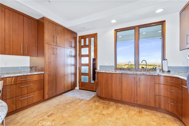 2340 Battering Rock Rd, Templeton, CA 93465 - kitchen featuring brown cabinets, recessed lighting, light stone countertops, light floors, and plenty of natural light