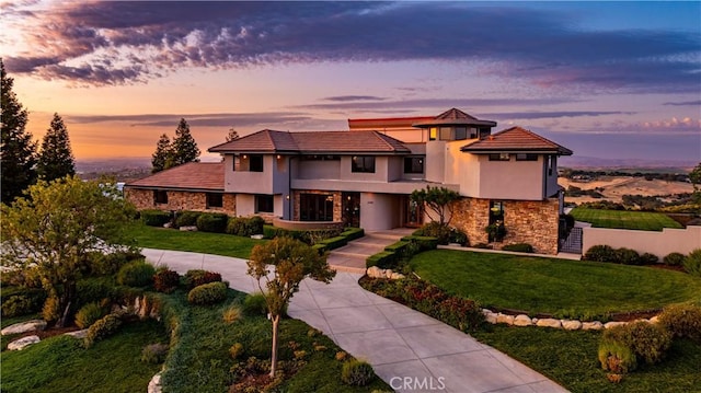 2340 Battering Rock Rd, Templeton, CA 93465 - view of front of home with stone siding, curved driveway, stucco siding, and a balcony