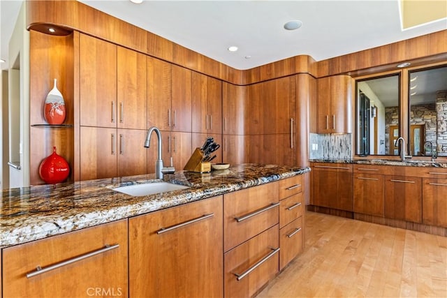 2340 Battering Rock Rd, Templeton, CA 93465 - kitchen with a sink, brown cabinets, dark stone counters, and light wood-style floors