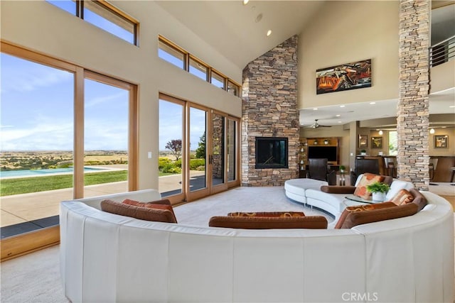 2340 Battering Rock Rd, Templeton, CA 93465 - carpeted living room with high vaulted ceiling, decorative columns, a ceiling fan, a stone fireplace, and recessed lighting