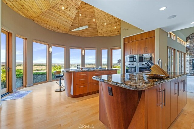 2340 Battering Rock Rd, Templeton, CA 93465 - kitchen with appliances with stainless steel finishes, brown cabinetry, a breakfast bar, a towering ceiling, and wood ceiling