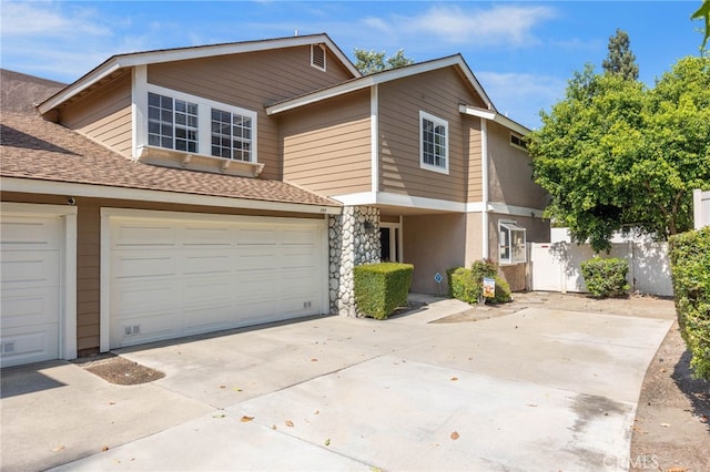 999 Alleghany Cir, San Dimas, CA 91773 - multi unit property with driveway, stone siding, roof with shingles, and an attached garage
