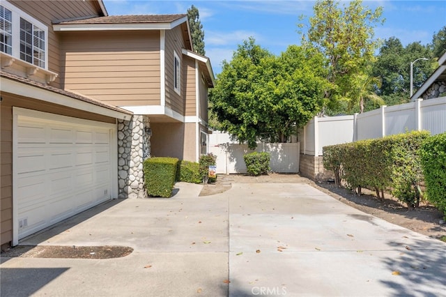 999 Alleghany Cir, San Dimas, CA 91773 - view of home's exterior featuring driveway and stone siding