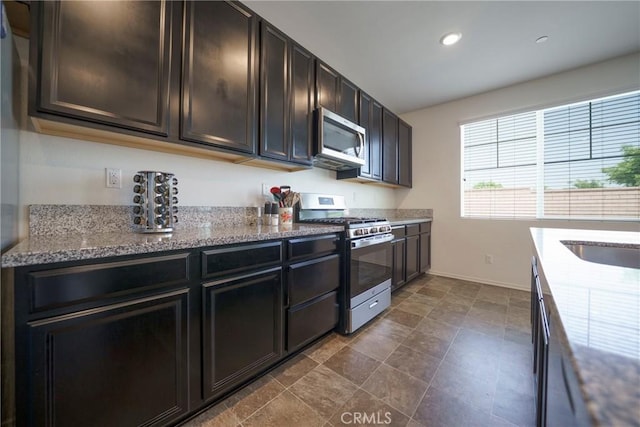 1172 Poinsettia Cir, Calimesa, CA 92320 - kitchen with stainless steel appliances, light stone countertops, recessed lighting, and dark brown cabinets