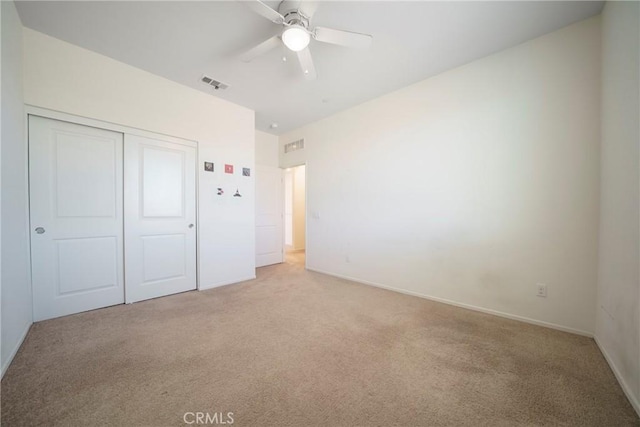 1172 Poinsettia Cir, Calimesa, CA 92320 - unfurnished bedroom with light carpet, a closet, and ceiling fan