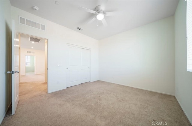 1172 Poinsettia Cir, Calimesa, CA 92320 - unfurnished bedroom with light colored carpet, a closet, and a ceiling fan