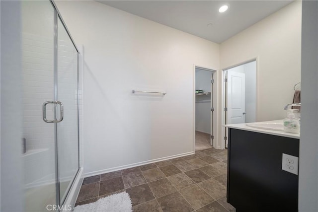 1172 Poinsettia Cir, Calimesa, CA 92320 - full bathroom featuring a shower stall, vanity, a walk in closet, and recessed lighting