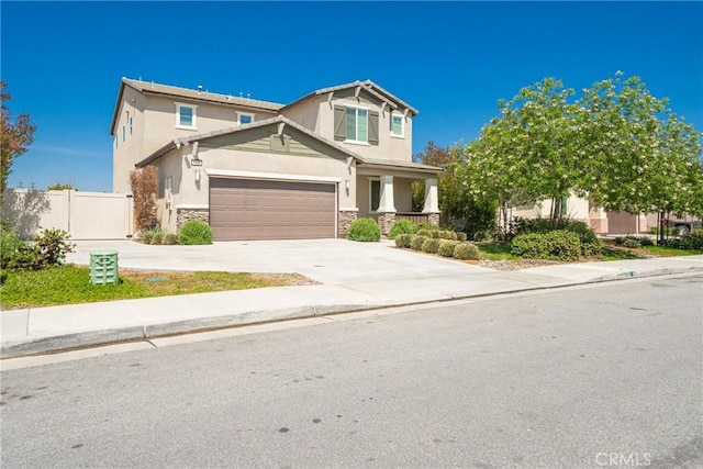 1172 Poinsettia Cir, Calimesa, CA 92320 - view of front of home with stone siding, concrete driveway, stucco siding, an attached garage, and a porch