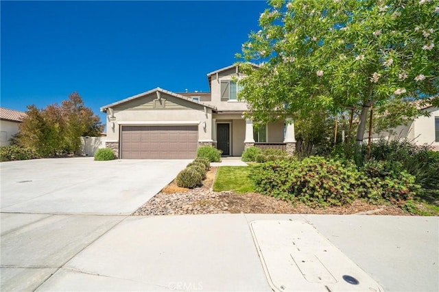 1172 Poinsettia Cir, Calimesa, CA 92320 - view of front of property featuring stucco siding, stone siding, an attached garage, driveway, and a porch